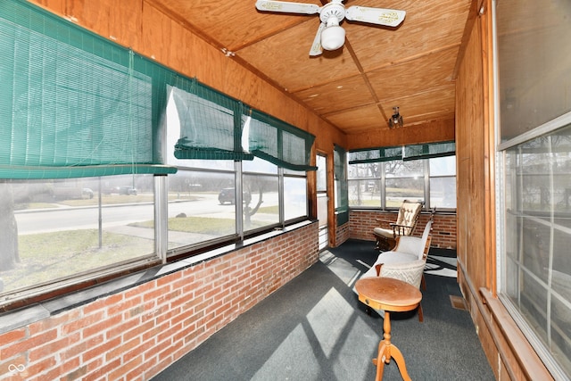 sunroom featuring ceiling fan and wooden ceiling