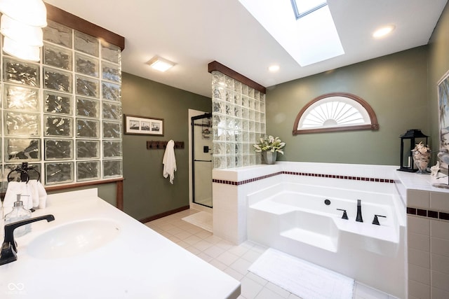 bathroom featuring tile patterned flooring, a garden tub, recessed lighting, a stall shower, and a sink