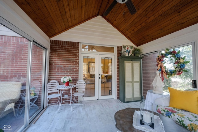 unfurnished sunroom with ceiling fan, french doors, wood ceiling, and lofted ceiling