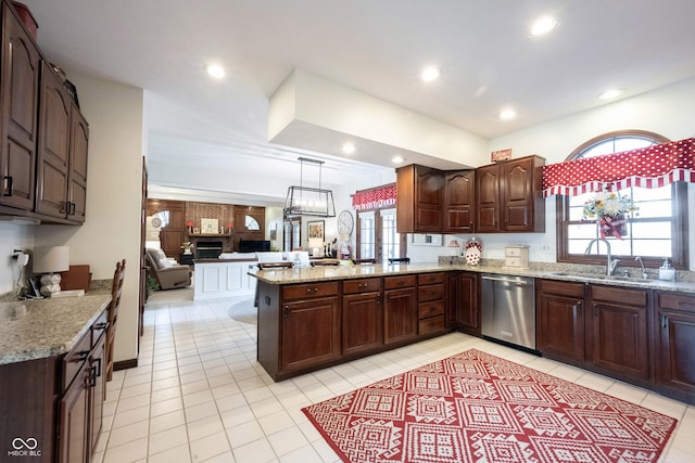 kitchen with a peninsula, recessed lighting, a sink, dark brown cabinetry, and stainless steel dishwasher