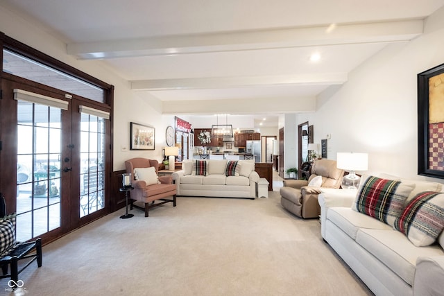 living room with light carpet, beamed ceiling, and french doors