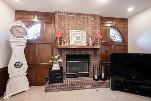 living area featuring a wealth of natural light, recessed lighting, a fireplace, and carpet floors