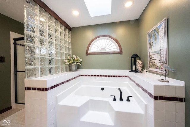 bathroom with a garden tub, a skylight, recessed lighting, and a shower stall