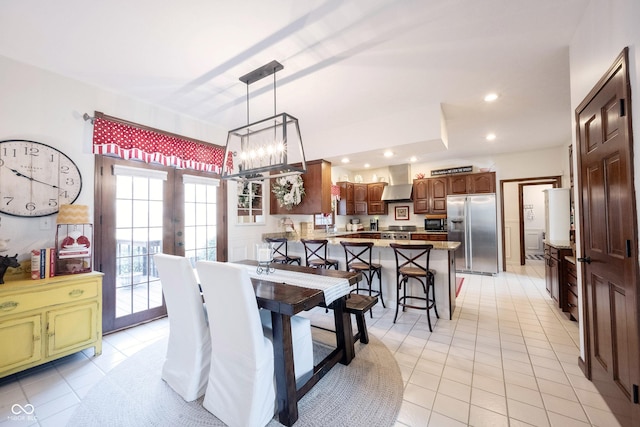 dining area with light tile patterned floors, recessed lighting, french doors, and an inviting chandelier