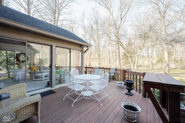 wooden terrace featuring outdoor dining area