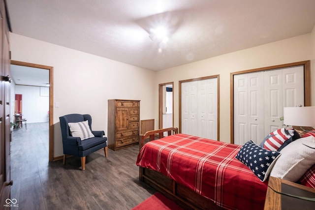 bedroom featuring multiple closets and dark wood-style flooring