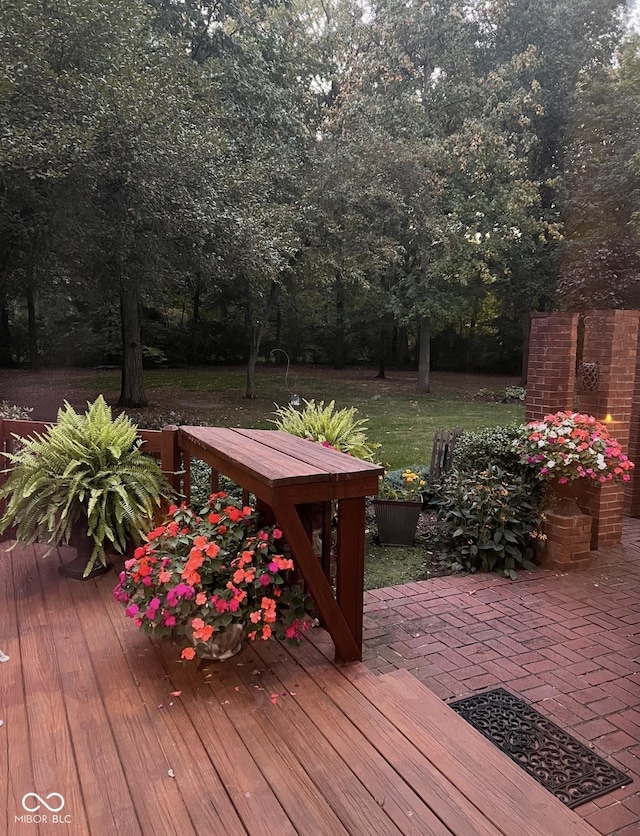 wooden deck with a patio and a yard