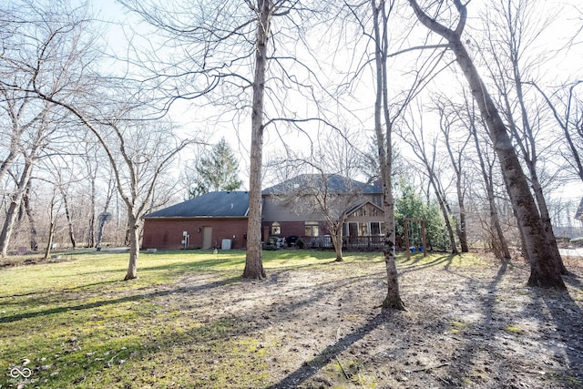 exterior space featuring a front yard and brick siding