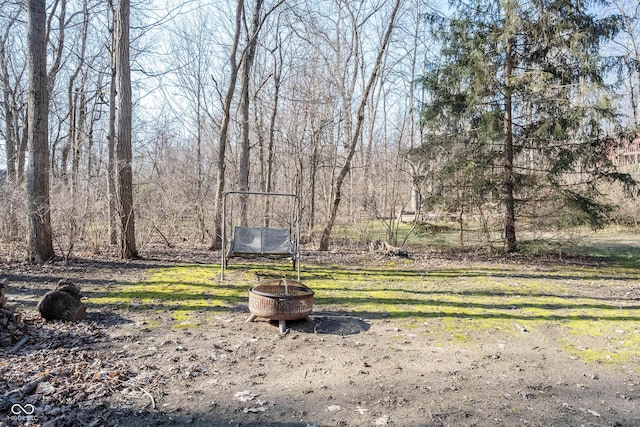 view of yard with a fire pit