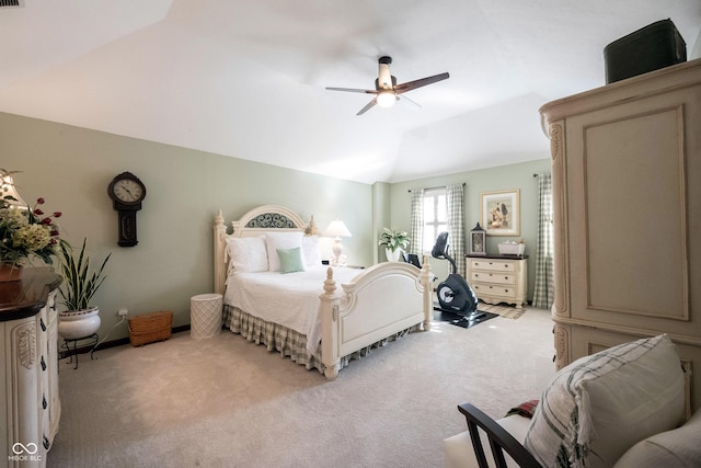 bedroom with lofted ceiling, a ceiling fan, and light carpet