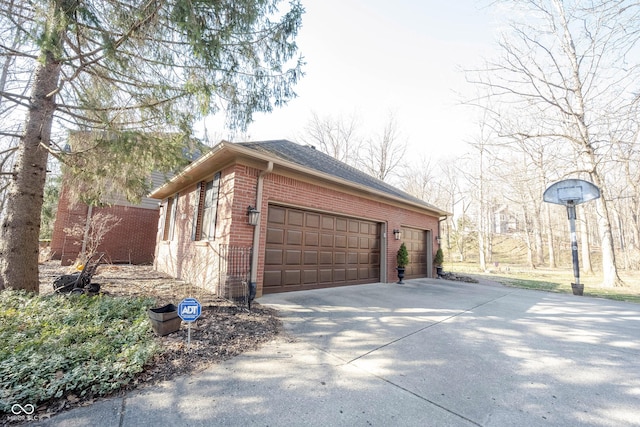 garage featuring concrete driveway