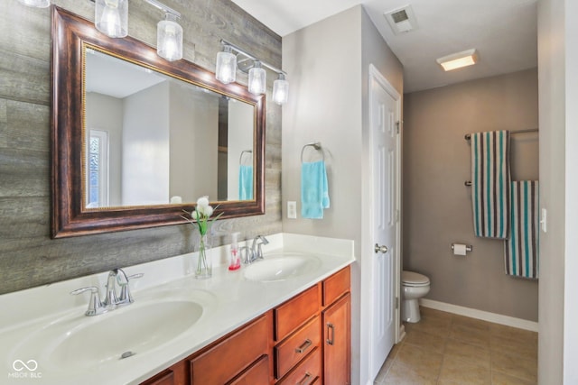 bathroom featuring double vanity, visible vents, tile patterned floors, and a sink