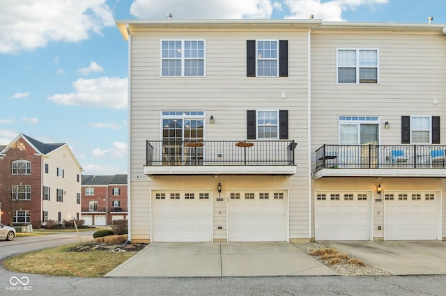 townhome / multi-family property featuring driveway and a garage