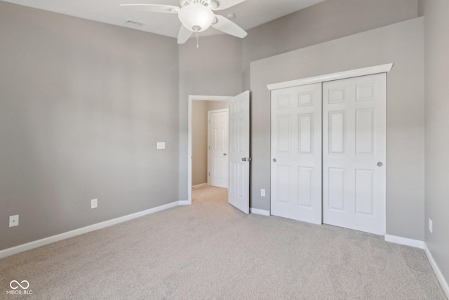 unfurnished bedroom with a closet, baseboards, carpet floors, and visible vents