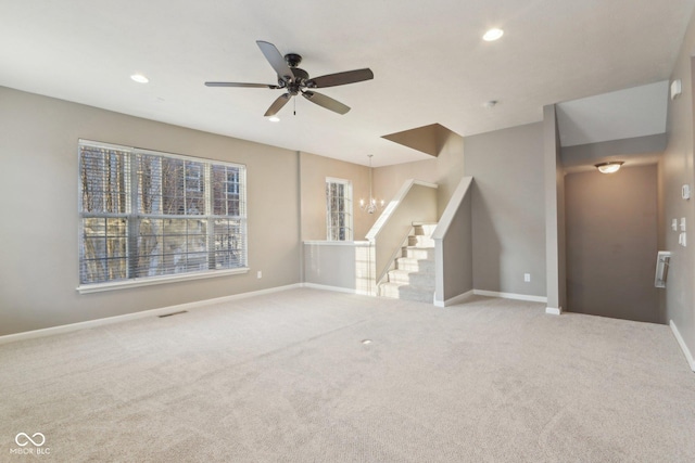 unfurnished living room with stairs, visible vents, recessed lighting, and carpet flooring