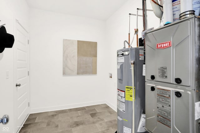 utility room with heating unit and electric water heater