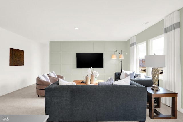 living room featuring carpet and baseboards