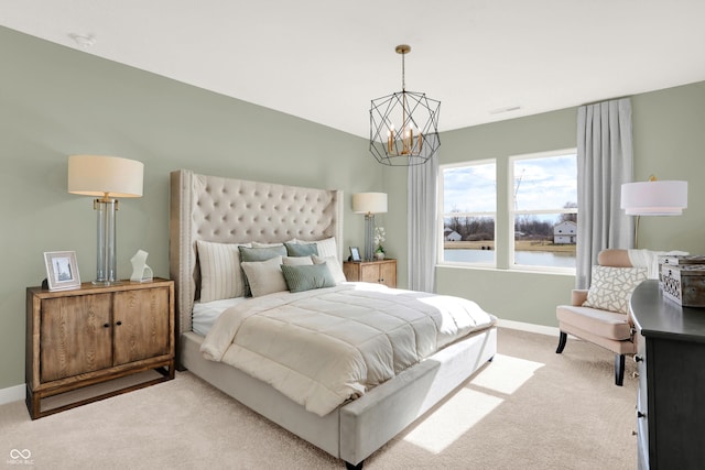 bedroom featuring a chandelier, carpet flooring, and baseboards