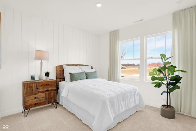 bedroom with visible vents and light colored carpet