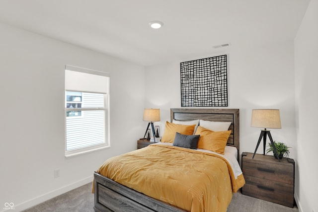 bedroom with visible vents, carpet floors, and baseboards