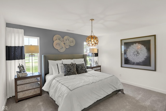 bedroom featuring carpet flooring, visible vents, and baseboards