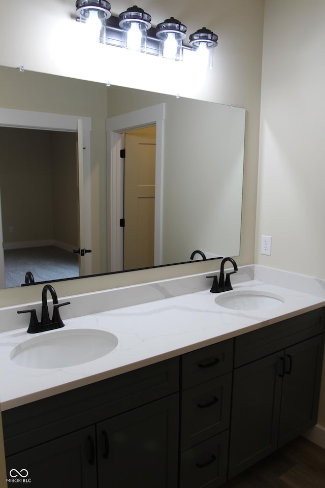 full bath featuring a sink and double vanity