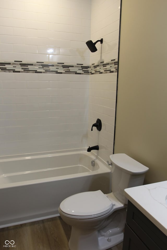 full bathroom with shower / bathtub combination, toilet, wood finished floors, and vanity