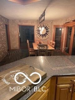 kitchen with dark countertops and brick wall