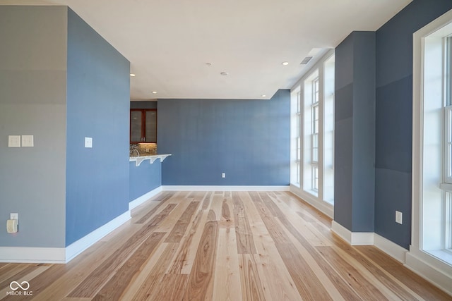 interior space featuring recessed lighting, visible vents, baseboards, and light wood finished floors