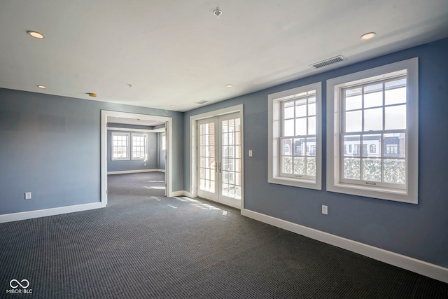 empty room featuring carpet, visible vents, baseboards, recessed lighting, and french doors