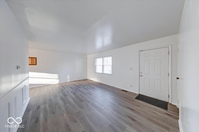 interior space featuring visible vents and wood finished floors