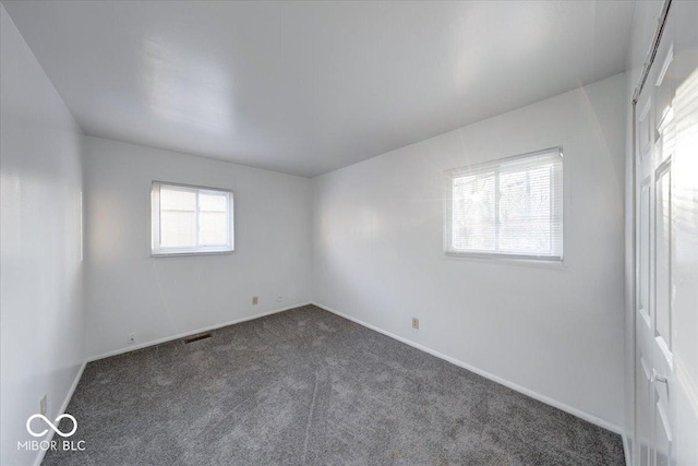 interior space featuring baseboards, visible vents, and carpet floors