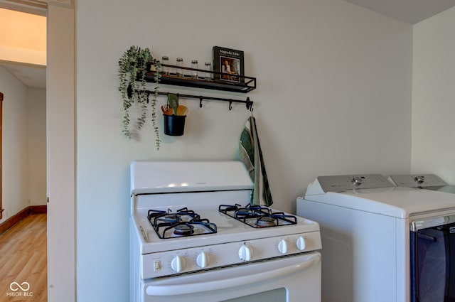 kitchen featuring baseboards, gas range gas stove, and light wood-style floors