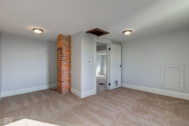 carpeted empty room featuring baseboards