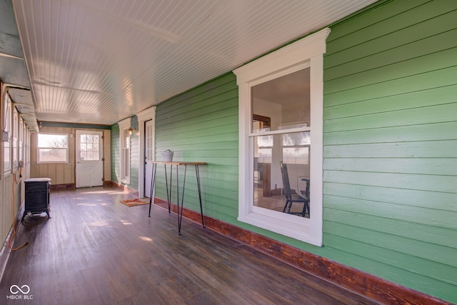 unfurnished sunroom featuring a wood stove