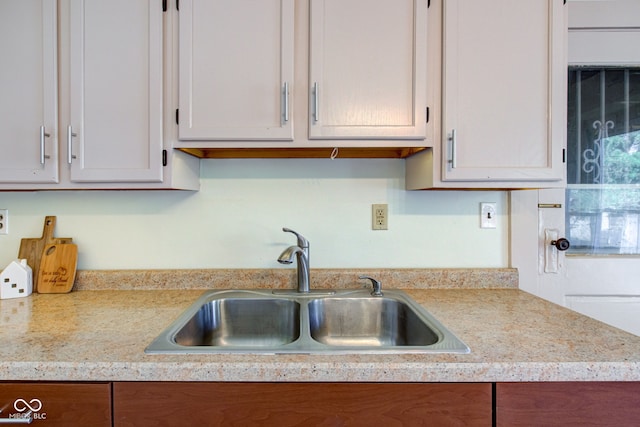 kitchen featuring light countertops and a sink