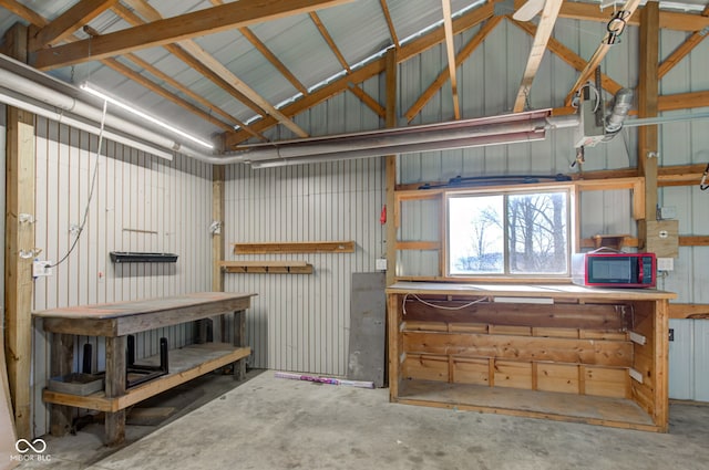 garage featuring a workshop area and metal wall