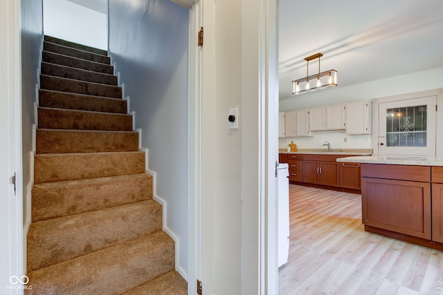 stairway with baseboards and wood finished floors