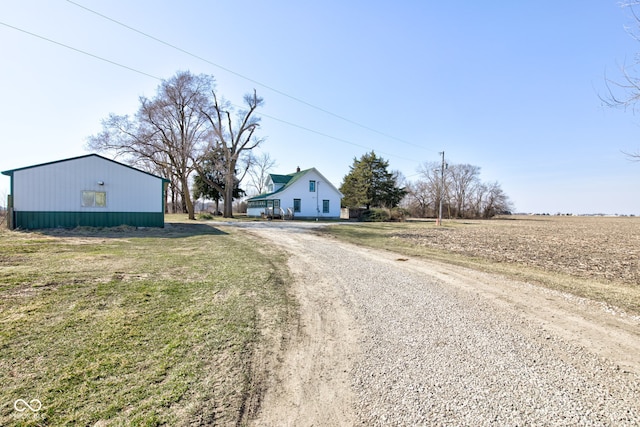 view of street featuring an outbuilding and driveway