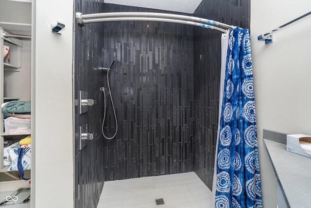 full bath featuring a tile shower