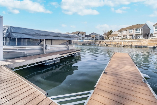 dock area with a residential view and a water view