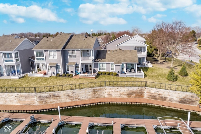 rear view of property with a yard, a residential view, and a fenced backyard