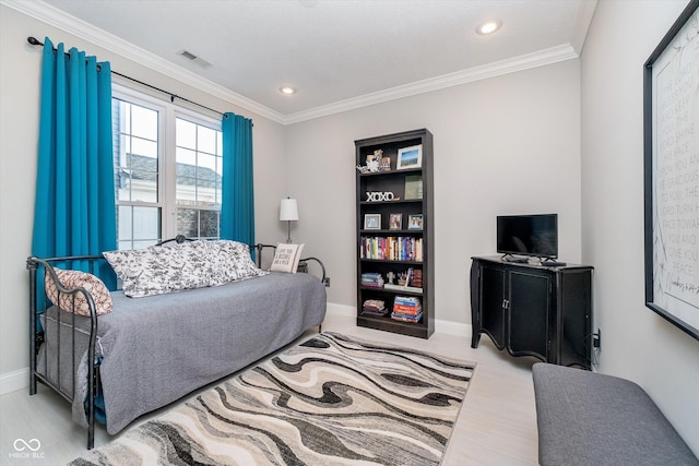 bedroom featuring baseboards, visible vents, and ornamental molding