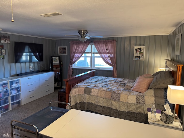 bedroom featuring crown molding, carpet flooring, a ceiling fan, and visible vents