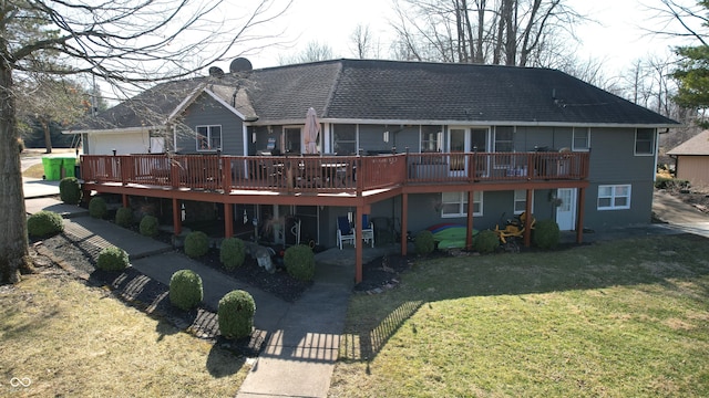 rear view of house featuring a yard and a wooden deck