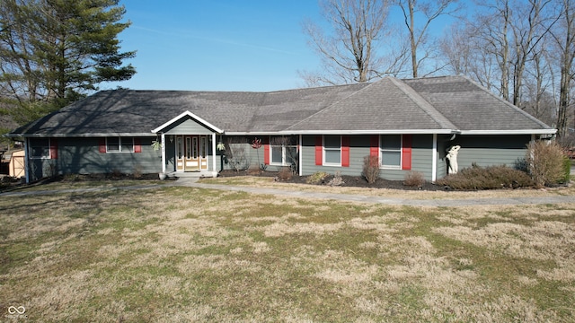 ranch-style house with a front lawn and roof with shingles