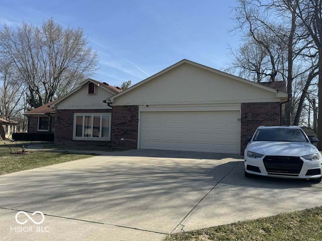 single story home with a garage, brick siding, and driveway