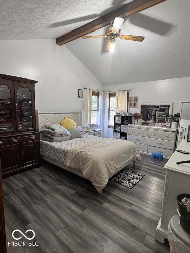 bedroom featuring lofted ceiling with beams, a ceiling fan, dark wood-type flooring, and a textured ceiling