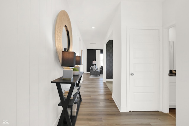 hallway featuring recessed lighting, baseboards, and wood finished floors