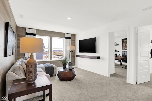 carpeted living area featuring recessed lighting, visible vents, and baseboards